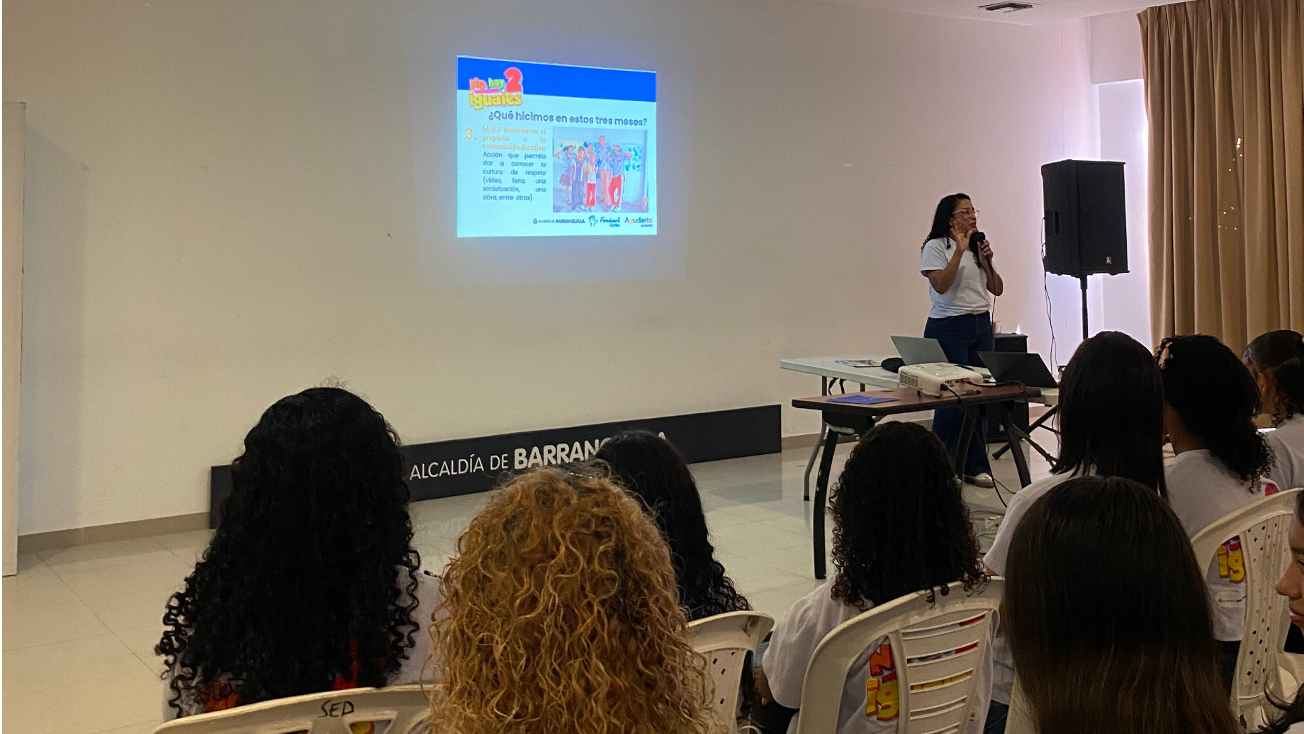 Auditorio y expositora. Mostrando diapositiva.